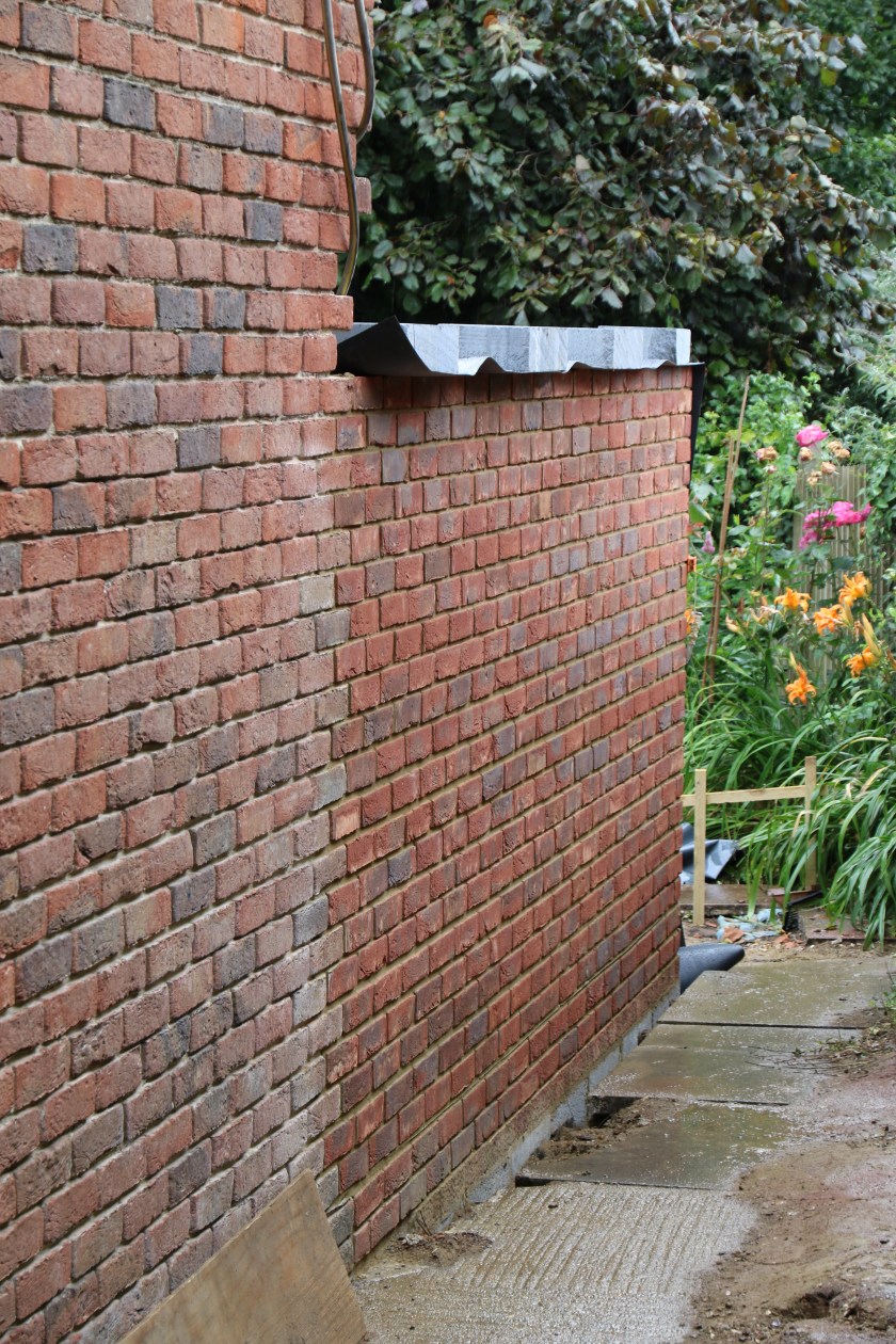 Conservatory - View down the side access. We need taller brickies to finish this wall.