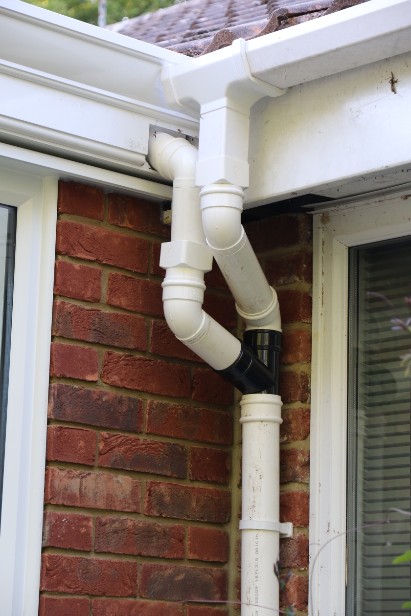Conservatory - Wall art ? Box gutter and house guttering. Temporary solution.