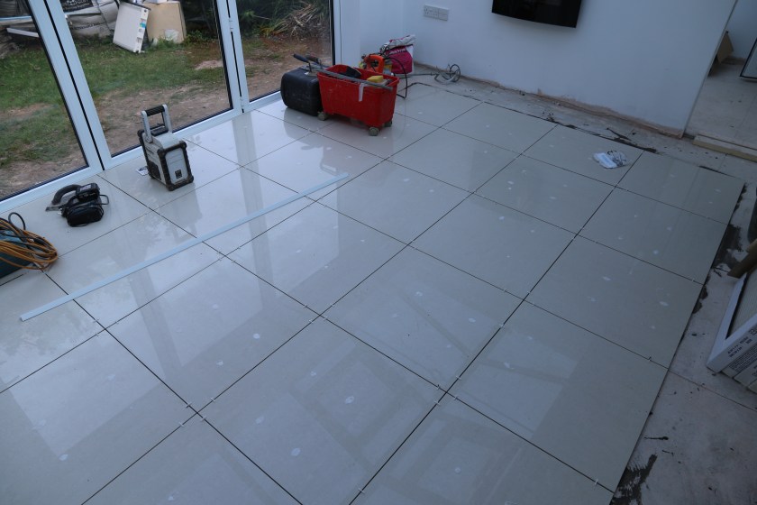 Conservatory - Floor tiling, no grout at this time.